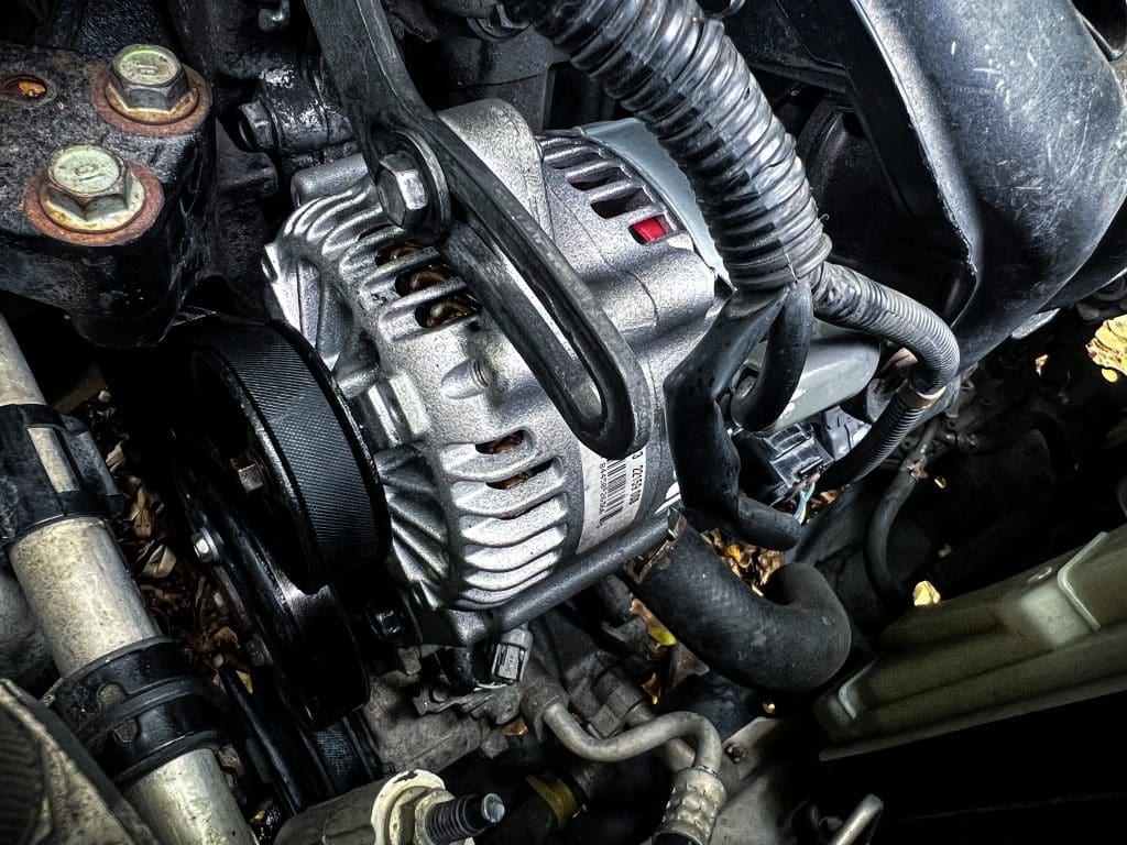 A close up of a car's alternator.