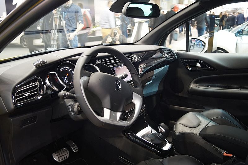 The interior of a car with leather seats and steering wheel.