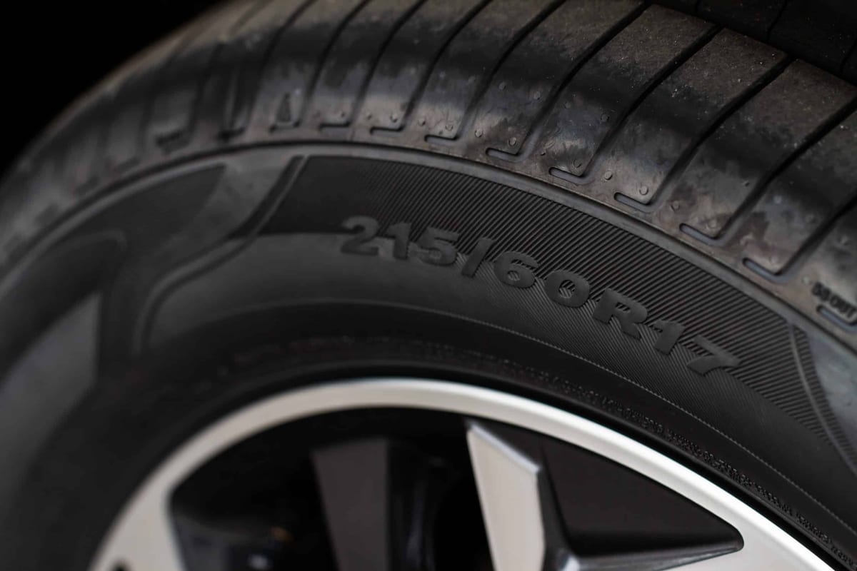 A close up of a tire on a black background.