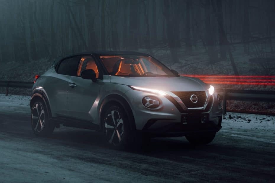 The nissan juke is driving down a snowy road.